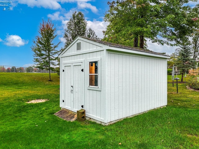 view of outdoor structure with a lawn