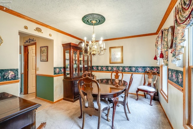 carpeted dining room featuring a textured ceiling, crown molding, and a notable chandelier