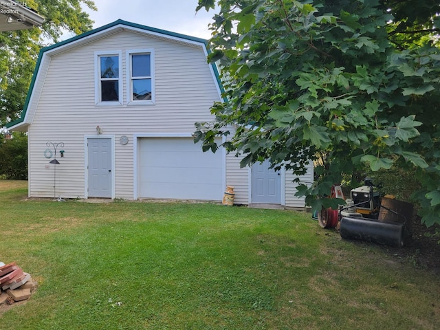 exterior space with a garage and a yard