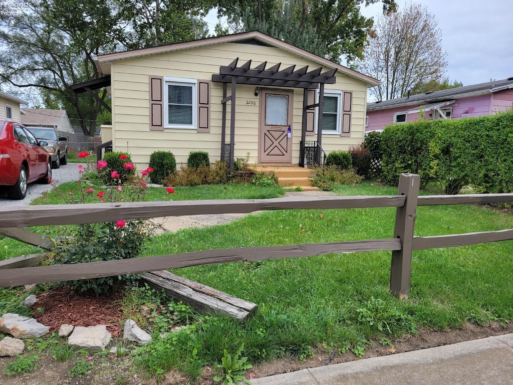 bungalow featuring a front lawn