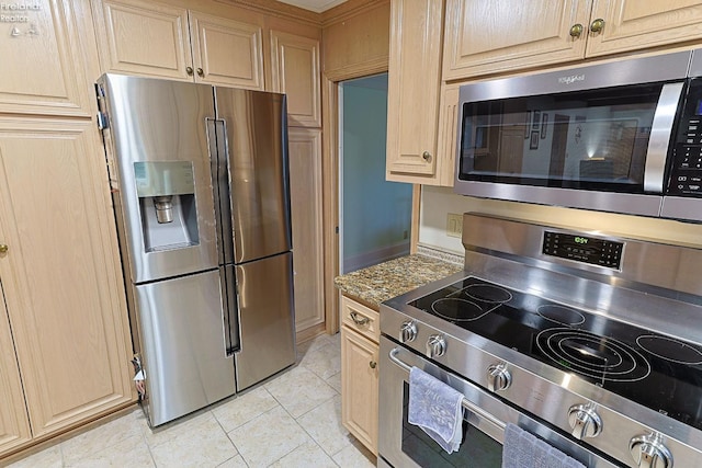 kitchen featuring light brown cabinetry, appliances with stainless steel finishes, and light tile patterned flooring