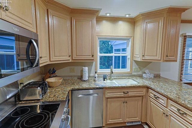 kitchen featuring light stone countertops, stainless steel appliances, sink, and light brown cabinets