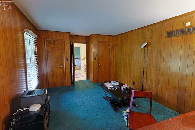 interior space featuring wood walls and dark carpet