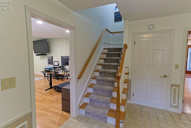 staircase with hardwood / wood-style flooring