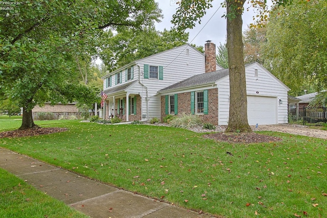 view of front of property with a front yard and a garage