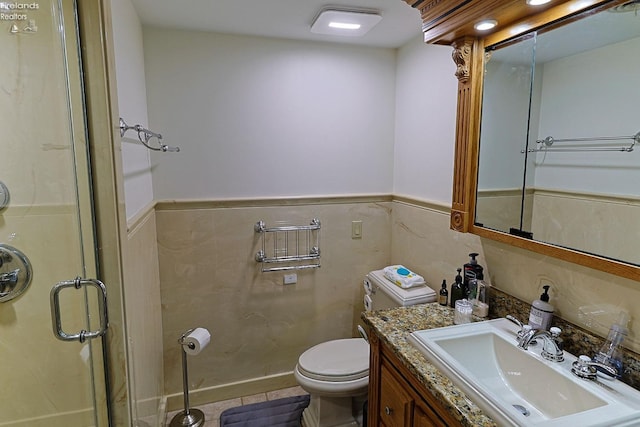 bathroom featuring vanity, toilet, and an enclosed shower