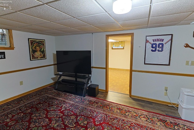 interior space featuring a paneled ceiling and hardwood / wood-style flooring