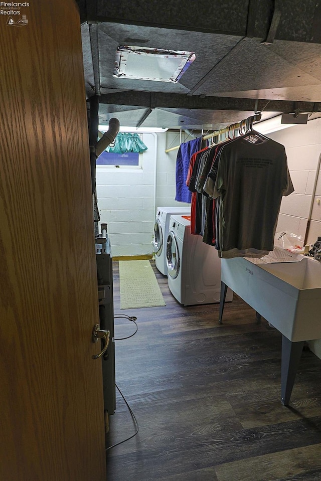 clothes washing area with separate washer and dryer and hardwood / wood-style floors