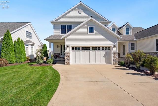 view of front of property with a front yard and a garage