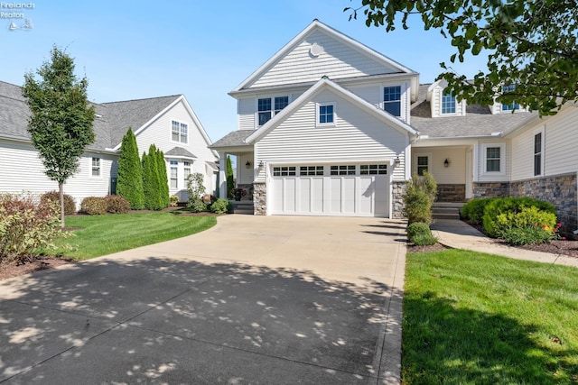 view of front facade featuring a front yard and a garage