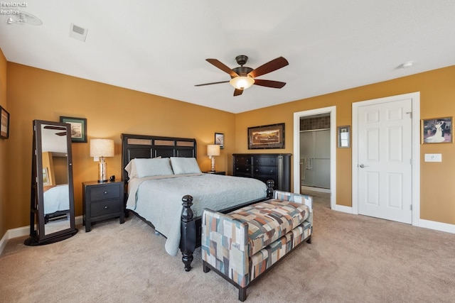 bedroom with a walk in closet, ceiling fan, light colored carpet, and a closet