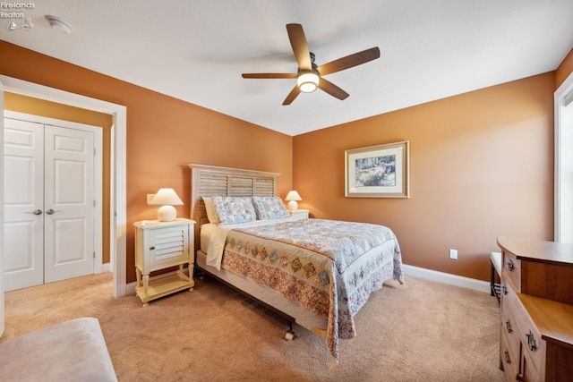 carpeted bedroom featuring ceiling fan and a closet