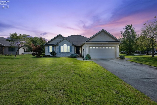 view of front of house featuring a garage and a yard