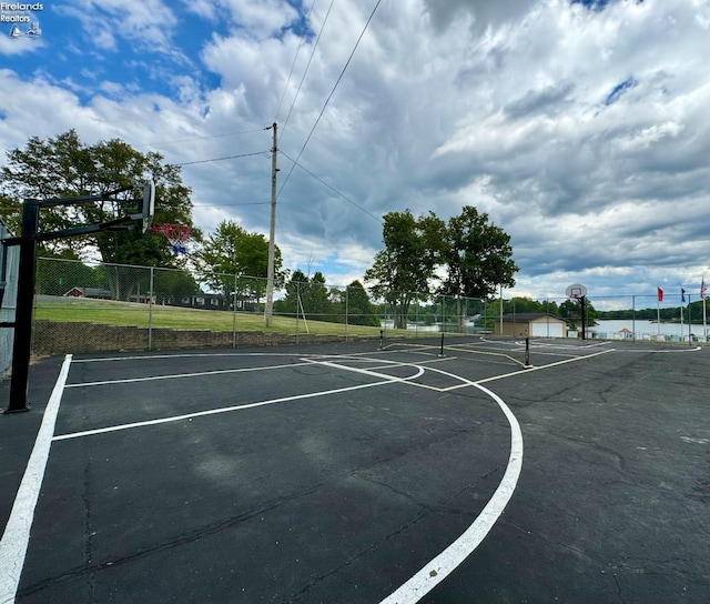 view of basketball court with fence and community basketball court