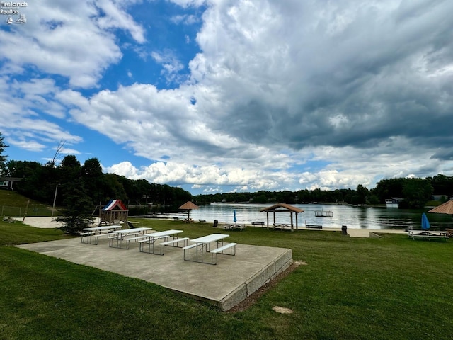 dock area featuring a water view and a yard