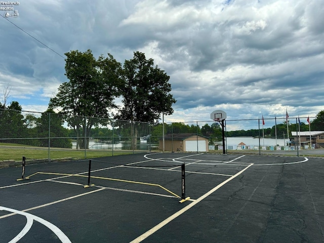 view of basketball court featuring a water view