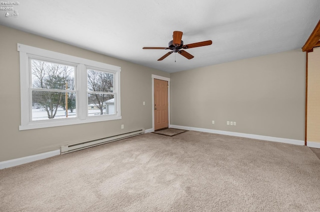 carpeted spare room featuring baseboards, a baseboard radiator, and a ceiling fan
