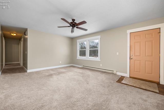 empty room with a baseboard radiator, ceiling fan, baseboards, and carpet floors