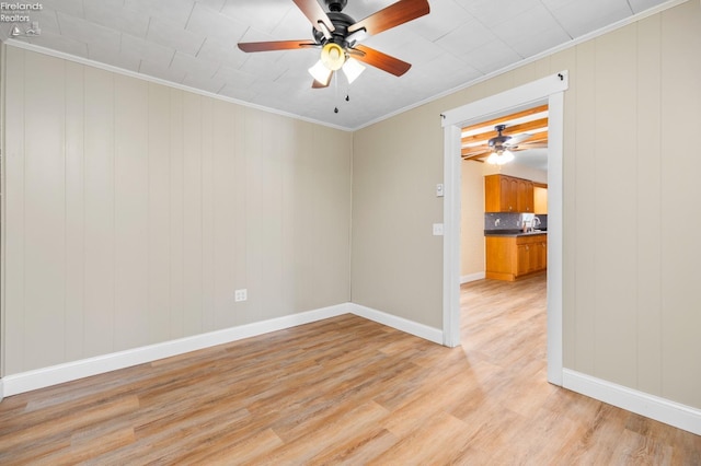 unfurnished room featuring crown molding, ceiling fan, and light hardwood / wood-style floors