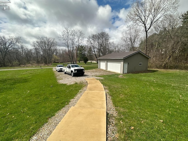 view of yard featuring an outbuilding and a garage