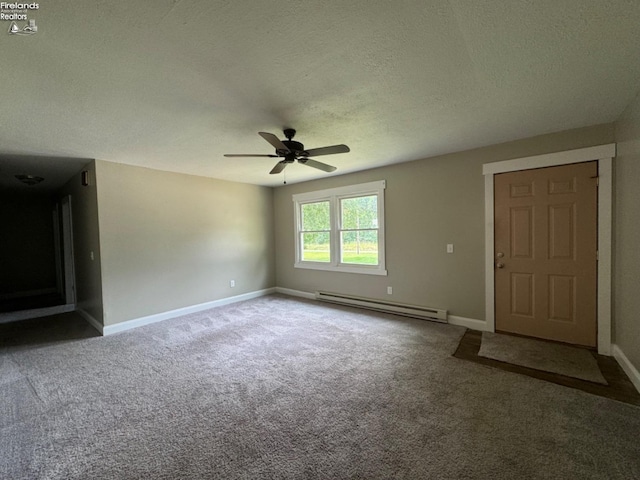 spare room featuring ceiling fan, carpet, a baseboard radiator, and a textured ceiling