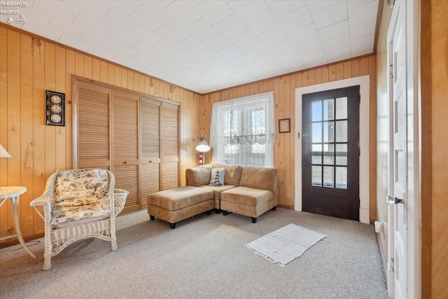 218 Lakefront, Lakeside, OH 43440 - living room featuring wooden walls, carpet flooring, and ornamental molding