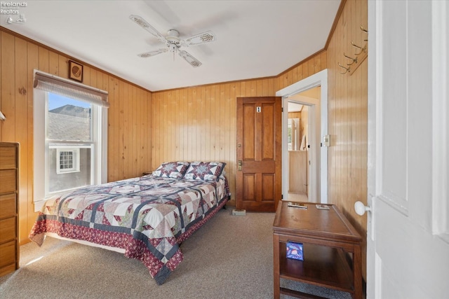 218 Lakefront, Lakeside, OH 43440 - carpeted bedroom with wood walls, ornamental molding, and a ceiling fan