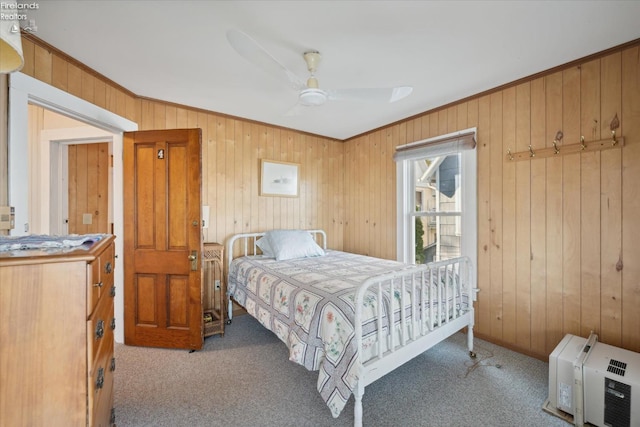 218 Lakefront, Lakeside, OH 43440 - carpeted bedroom with wood walls, ornamental molding, a ceiling fan, and heating unit