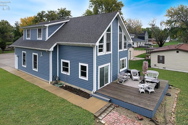 back of property featuring a yard and a wooden deck