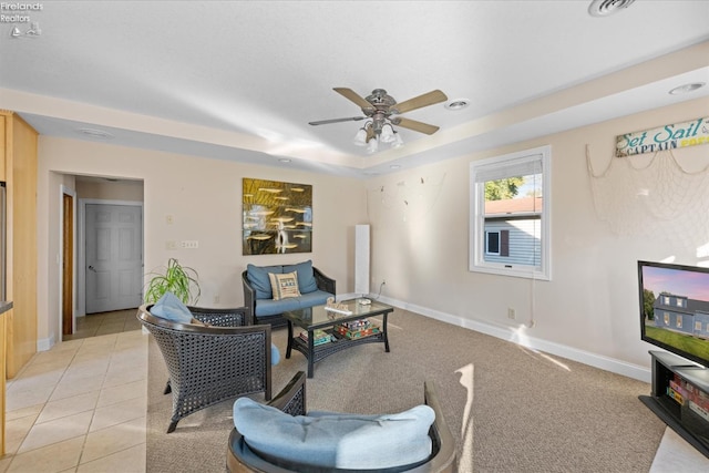 living room with ceiling fan and light tile patterned floors