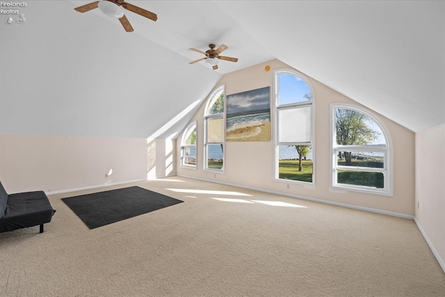 bonus room with ceiling fan, vaulted ceiling, and light colored carpet