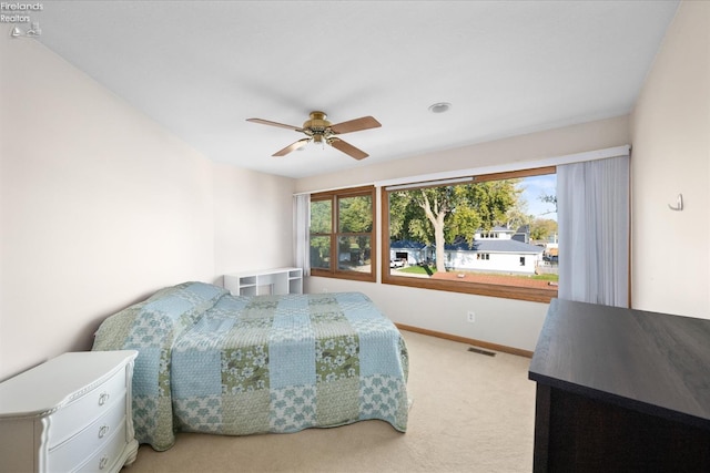 bedroom featuring ceiling fan and light colored carpet