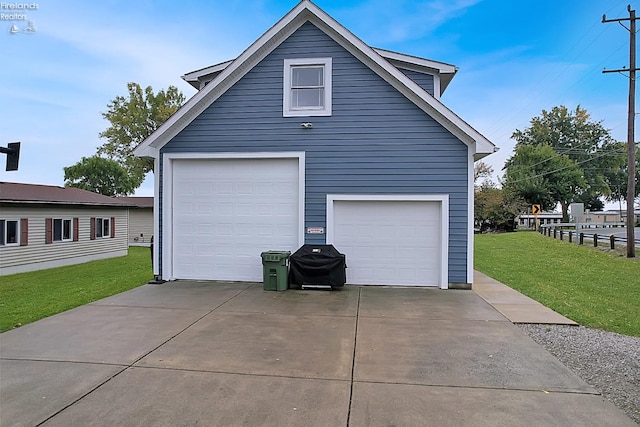 garage featuring a lawn