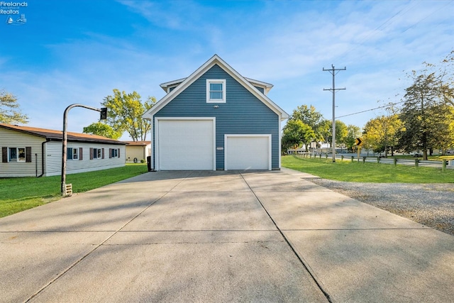 view of property exterior with a garage and a yard