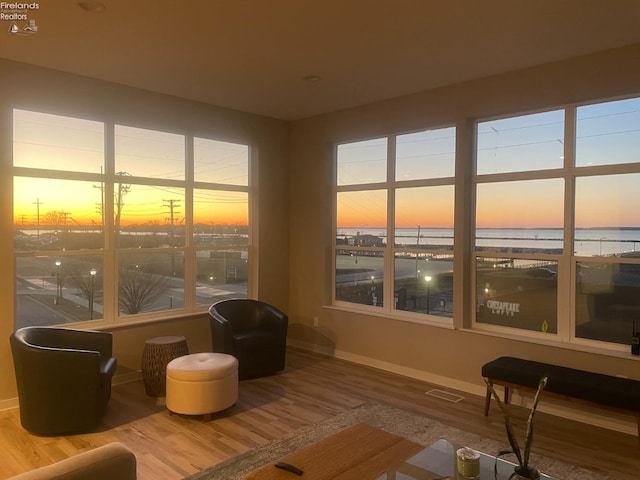 sunroom / solarium featuring a water view