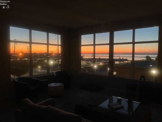 sunroom / solarium featuring a water view