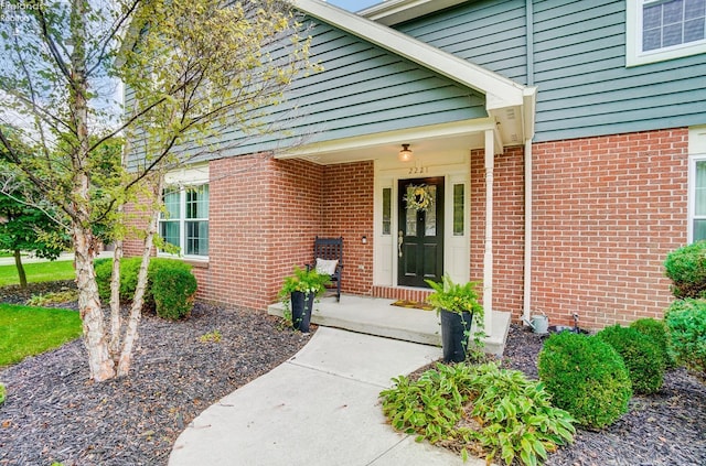 view of exterior entry with covered porch