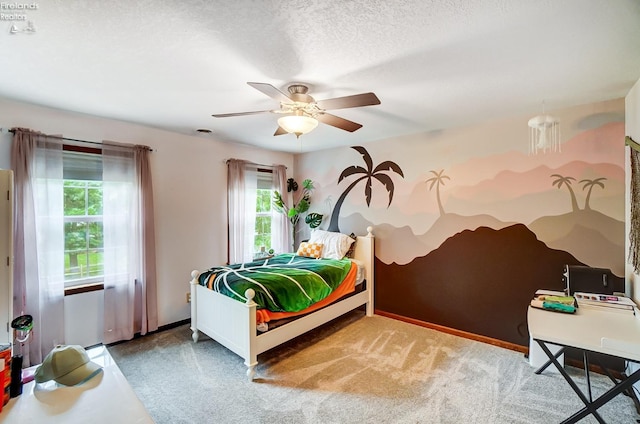 bedroom featuring a textured ceiling, ceiling fan, and carpet flooring