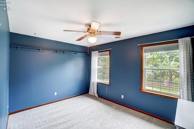 unfurnished bedroom with multiple windows, ceiling fan, and carpet floors