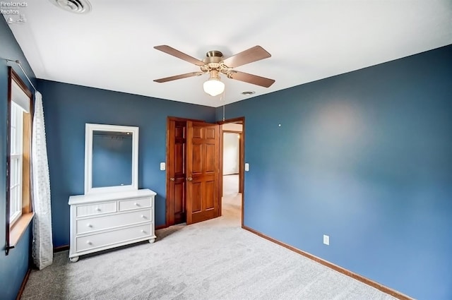 unfurnished bedroom with ceiling fan and light carpet