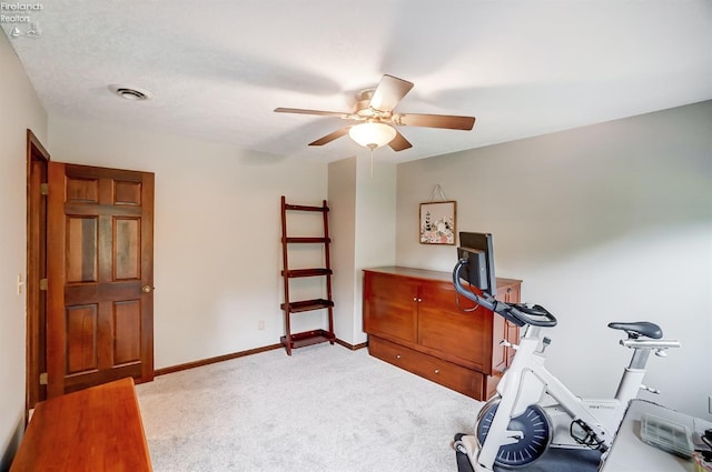 workout room featuring ceiling fan, a textured ceiling, and carpet flooring