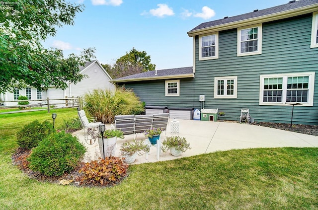 rear view of house with a yard and a patio area