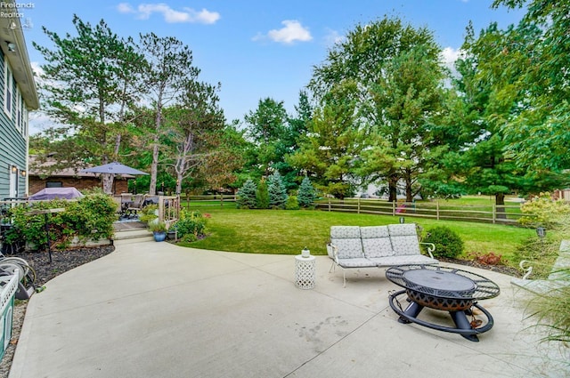 view of patio / terrace featuring an outdoor fire pit