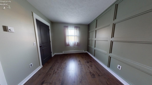 interior space with a textured ceiling, a closet, a baseboard heating unit, and dark hardwood / wood-style flooring