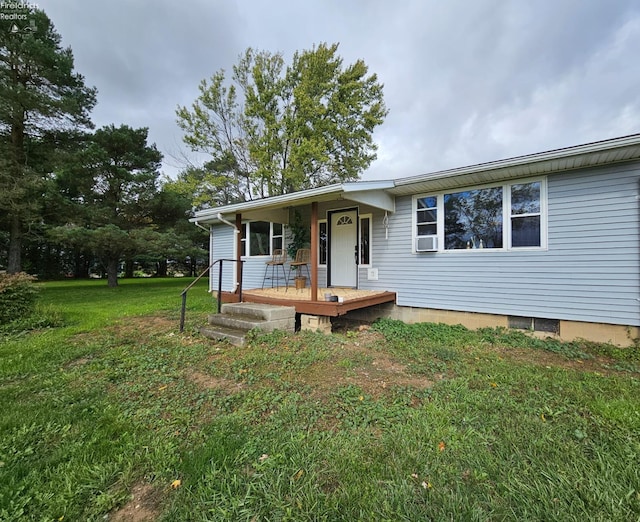 view of front of house featuring a front yard and cooling unit