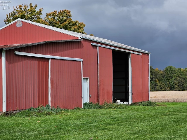 view of outbuilding with a lawn