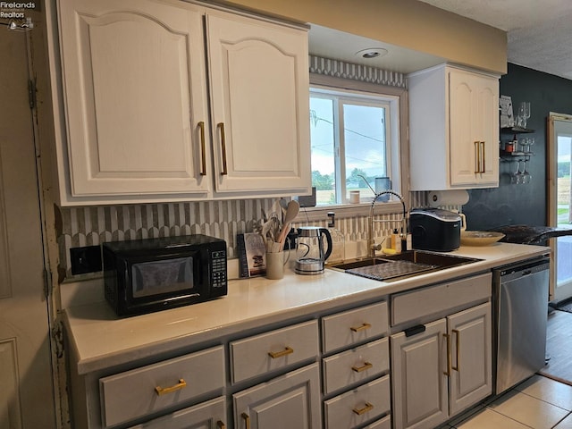 kitchen with sink, white cabinetry, gray cabinets, light tile patterned floors, and dishwasher