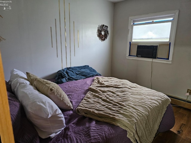 bedroom with dark wood-type flooring and cooling unit