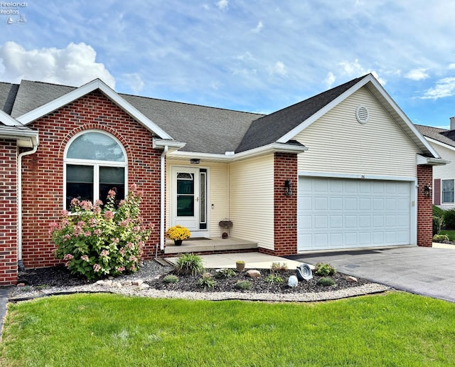 ranch-style home featuring a garage and a front yard