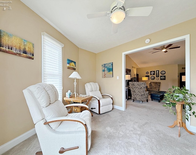 living area featuring ceiling fan and light colored carpet